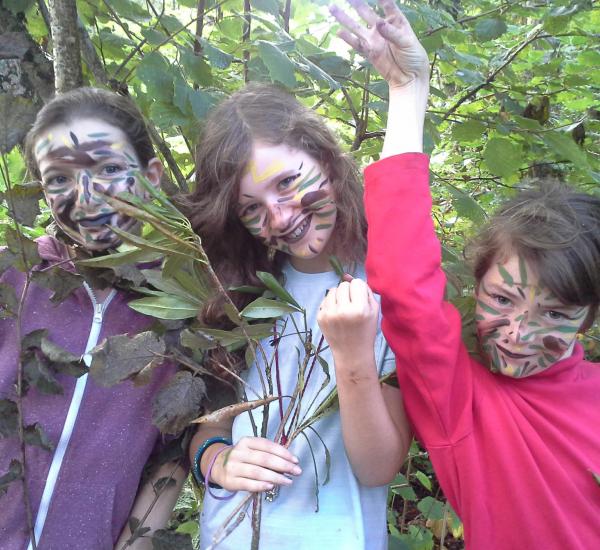Children in camouflage in the woods