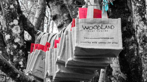 Bespoke party bags hanging from a tree in the woods
